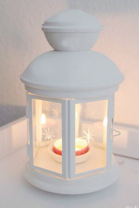 Photo B white hexagonal lantern with candle